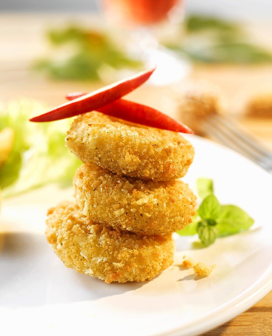 Breaded and deep-fried mini-Camemberts, stacked