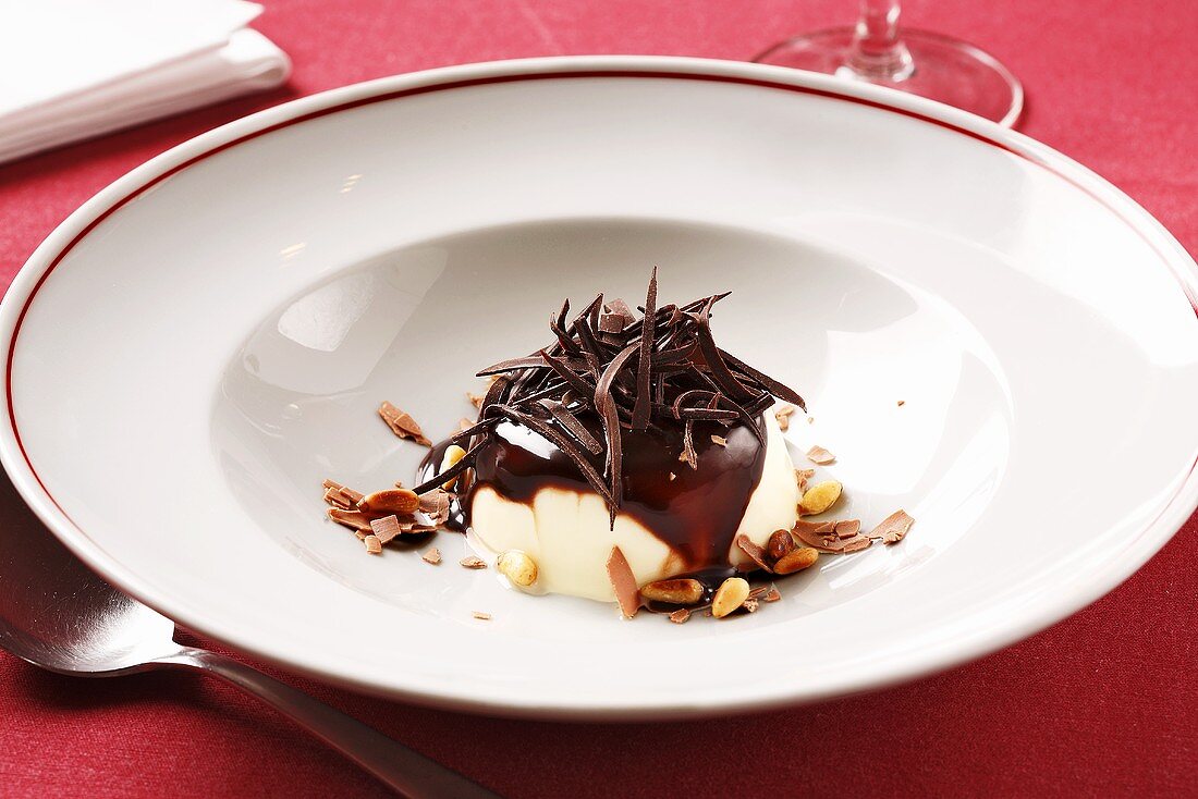 Ice cream with chocolate sauce and pine nuts
