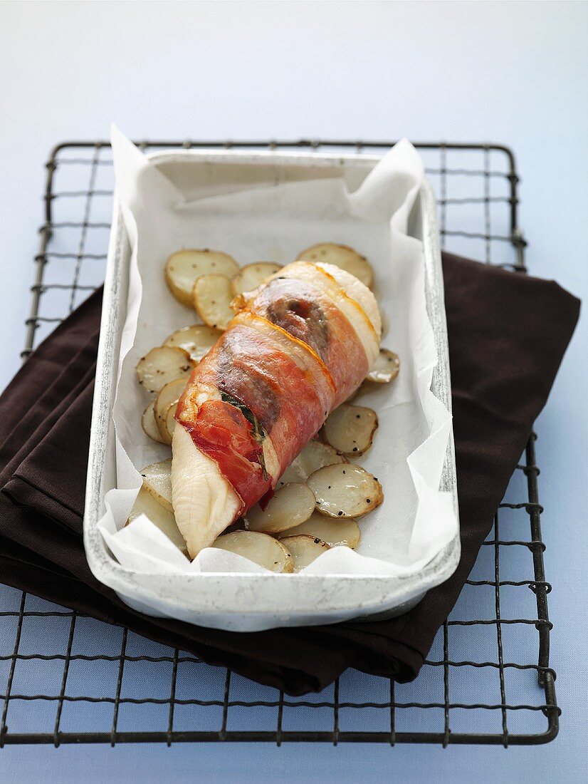 Prosciutto-wrapped chicken breast with potatoes