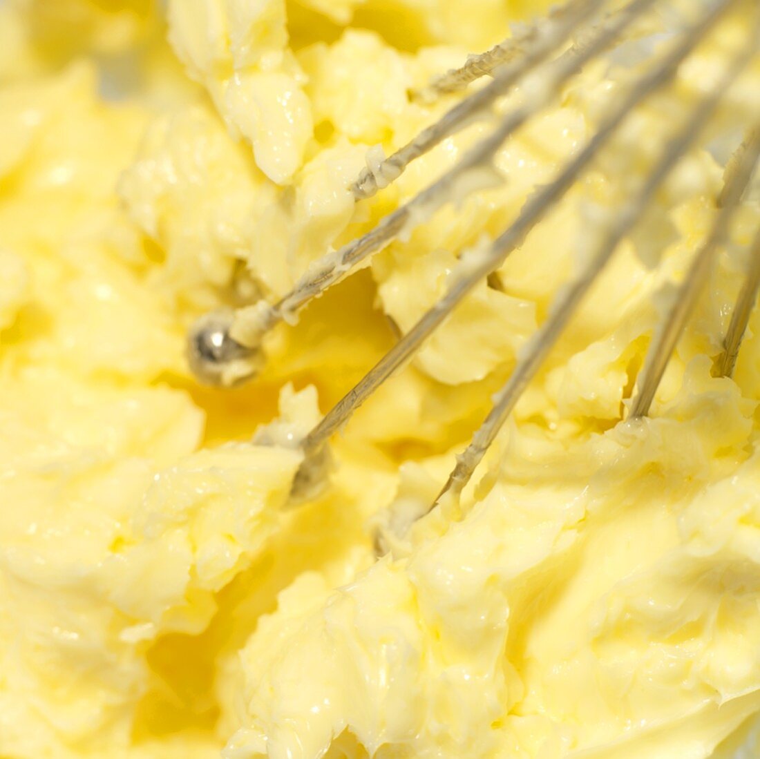 Beating butter with a whisk (close-up)