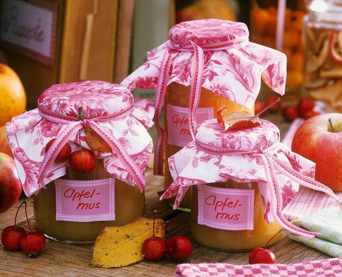Jars of apple puree with fabric covers, crab apple decoration