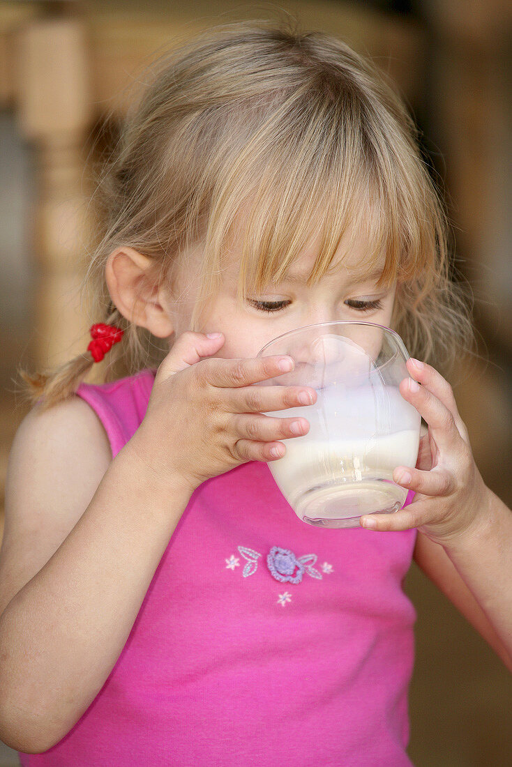 Girl drinking a glass of milk