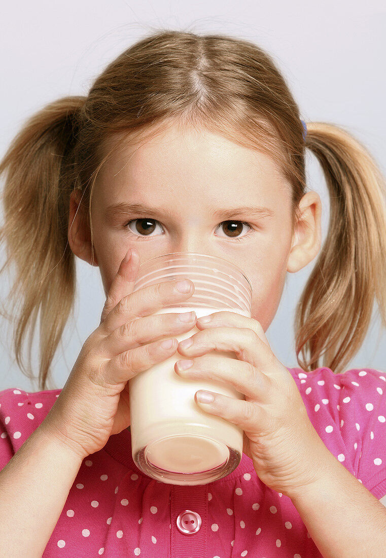 Girl drinking a glass of milk