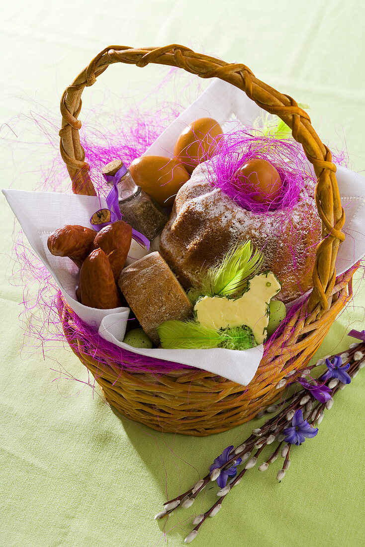 Sausage, eggs and baba (Polish rum cake) in Easter basket