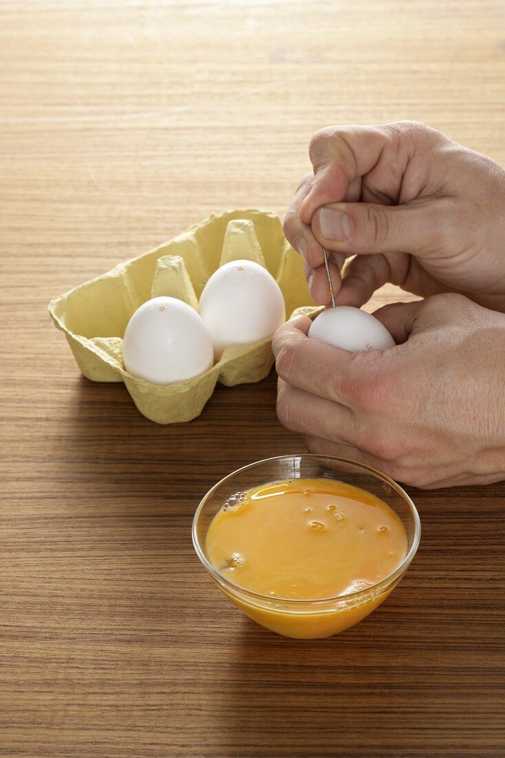 Blowing eggs (making a hole in the egg with a needle)