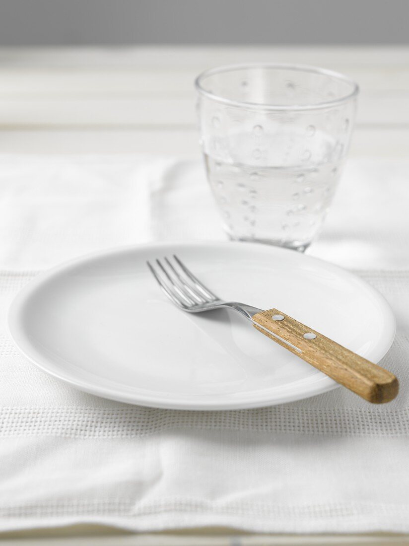 Plate with fork and a glass of water