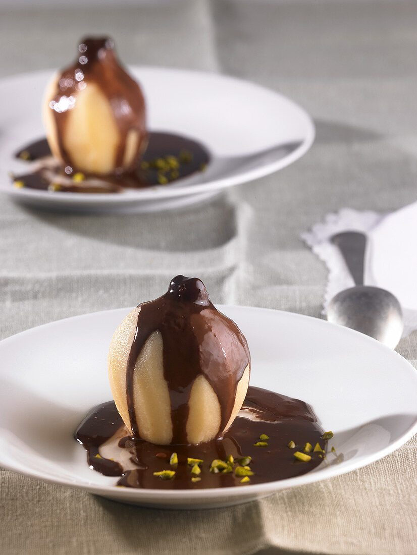 Quinces cooked in white wine with chocolate sauce