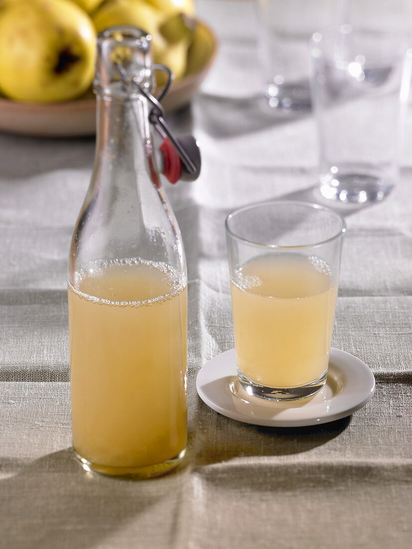 Quince juice in flip-top bottle and in glass