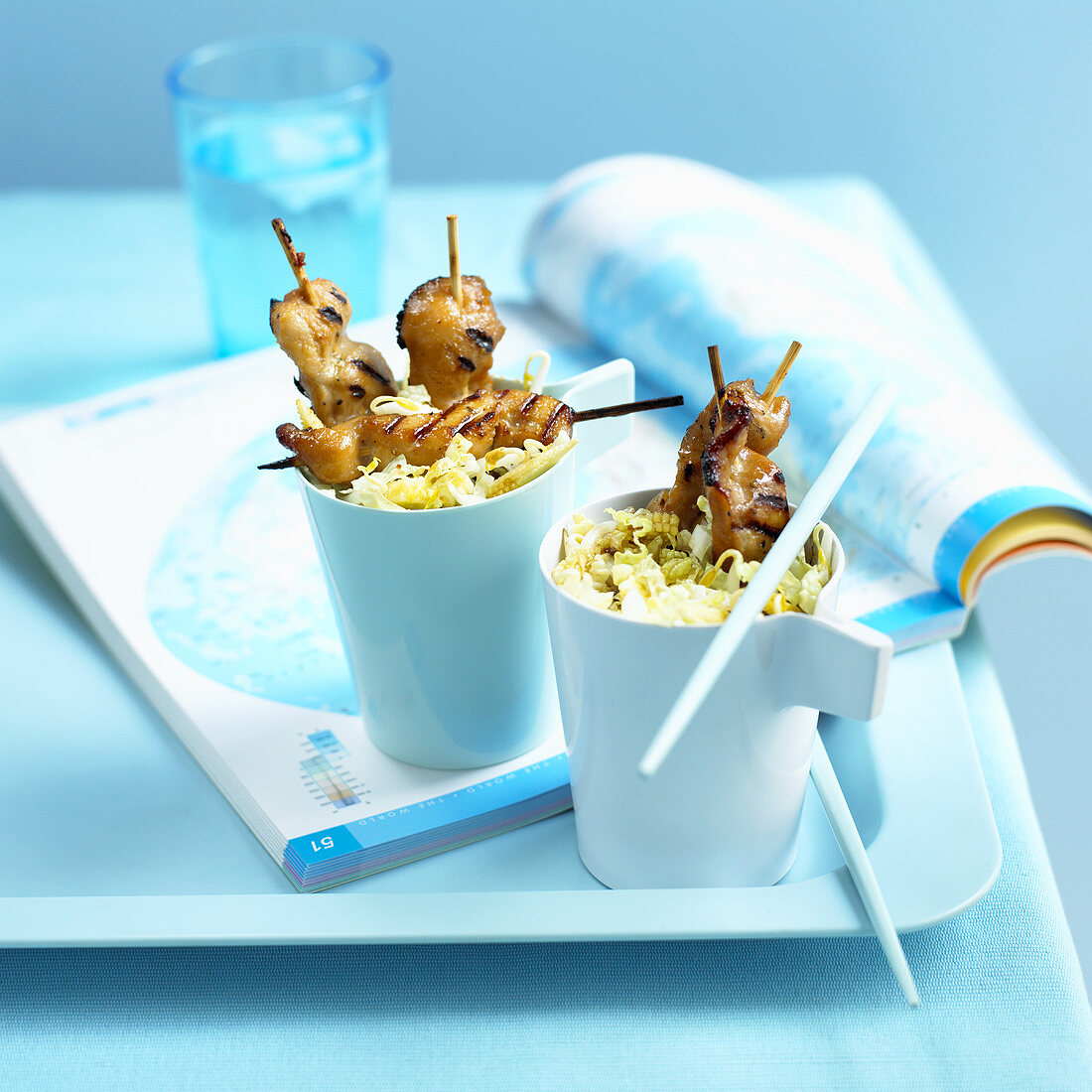 Skewered chicken with Chinese cabbage salad in beakers