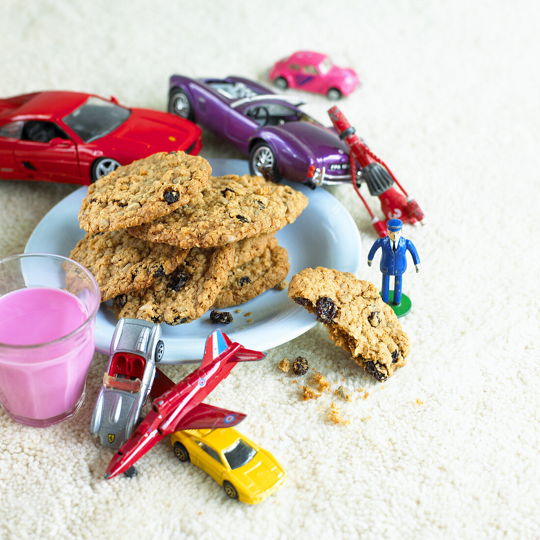 Oat and raisin biscuits, berry milk and toy cars