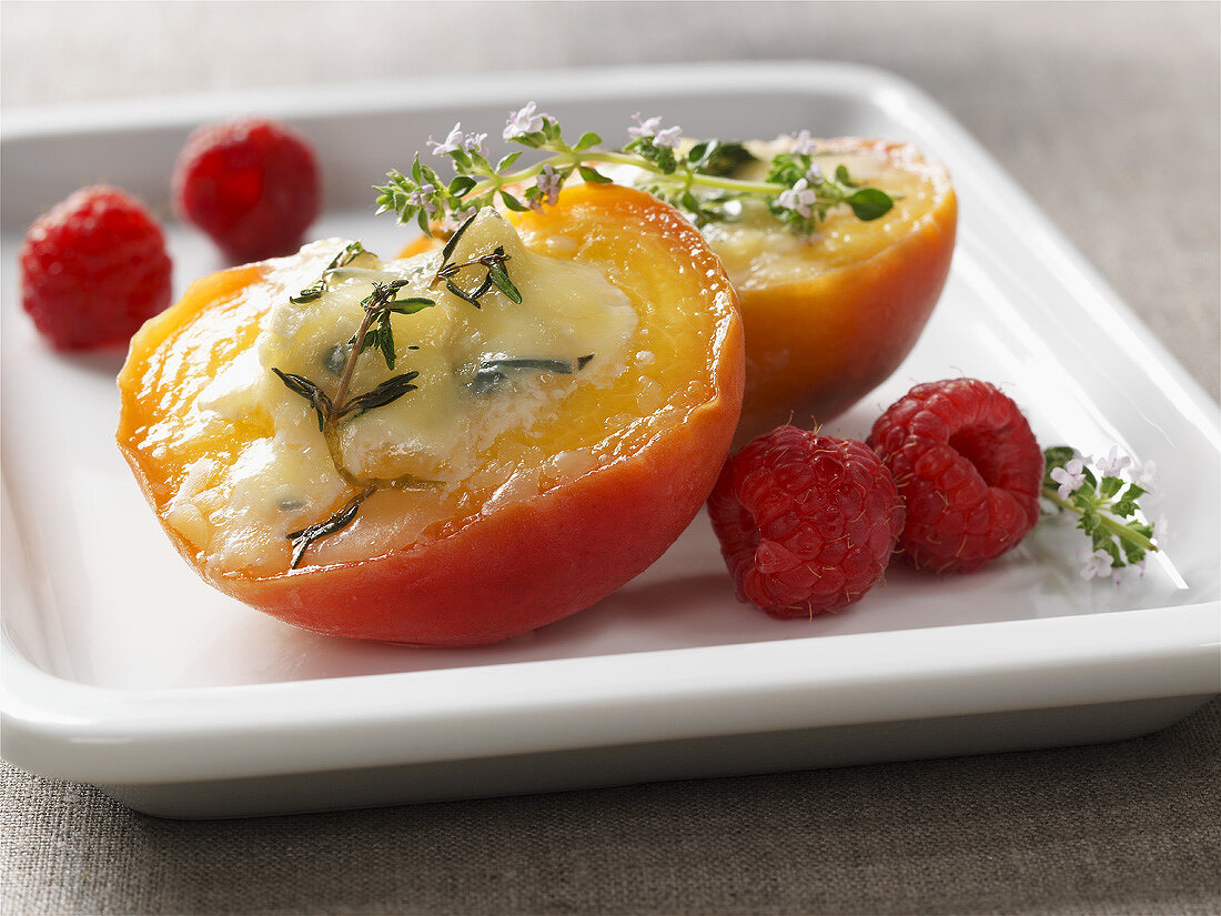 Baked peach with cheese stuffing and raspberries