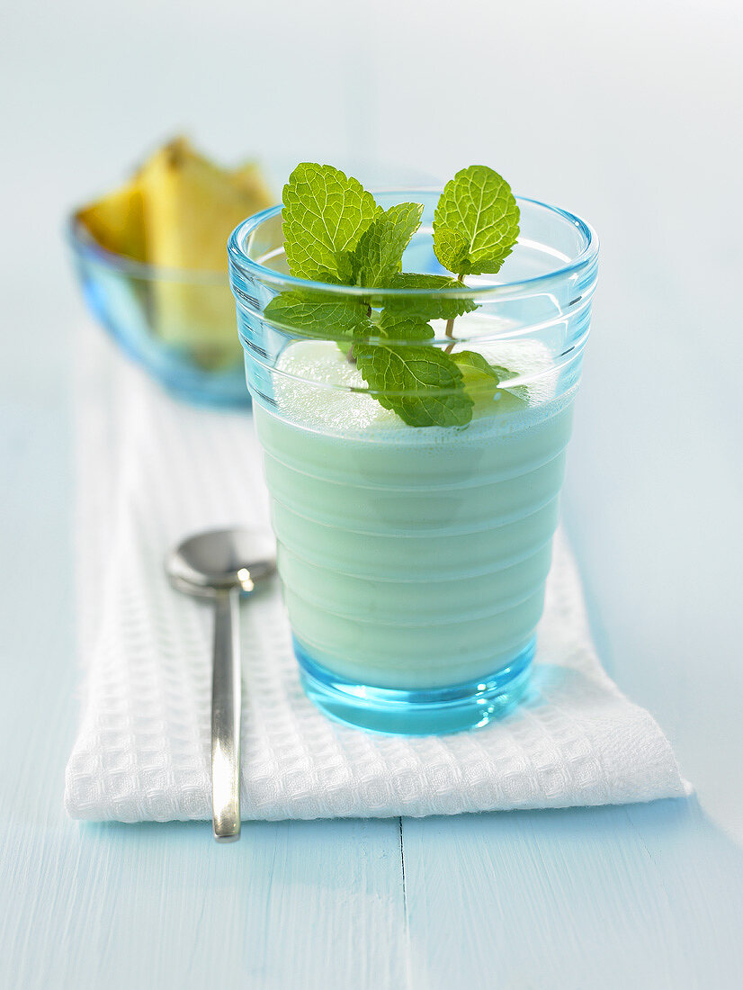 Pineapple buttermilk smoothie with mint leaves