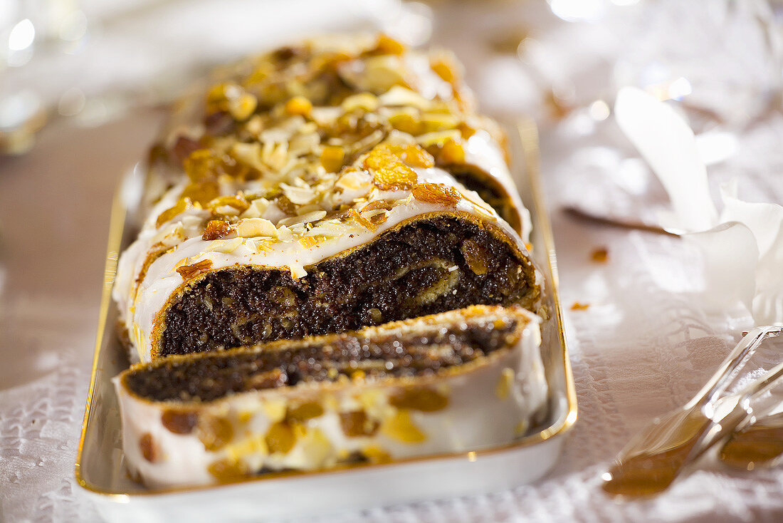 Polish poppy seed roll with icing and nuts