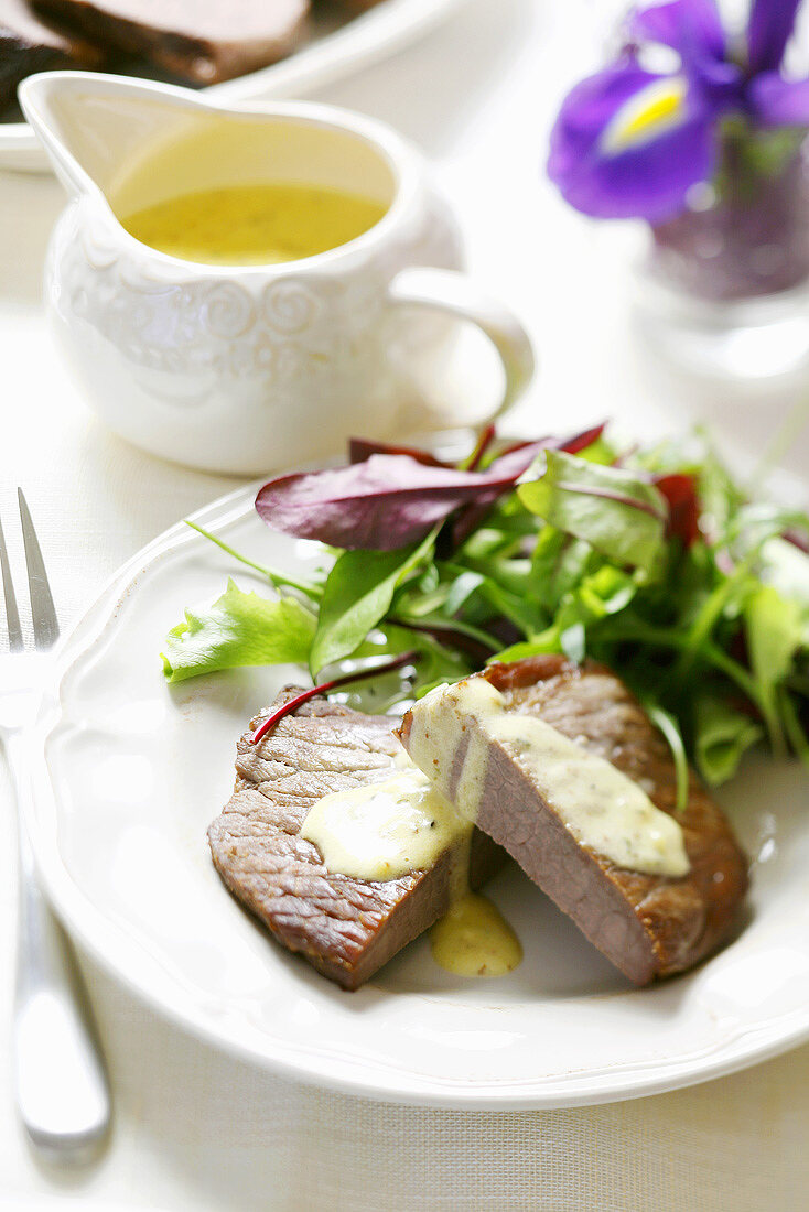 Cold roast beef with mustard sauce and salad