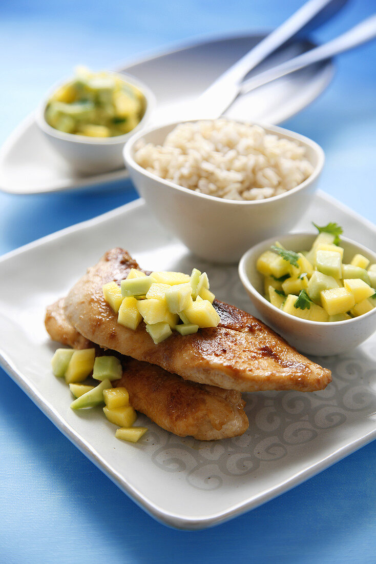 Chicken breast with warm mango and avocado salsa