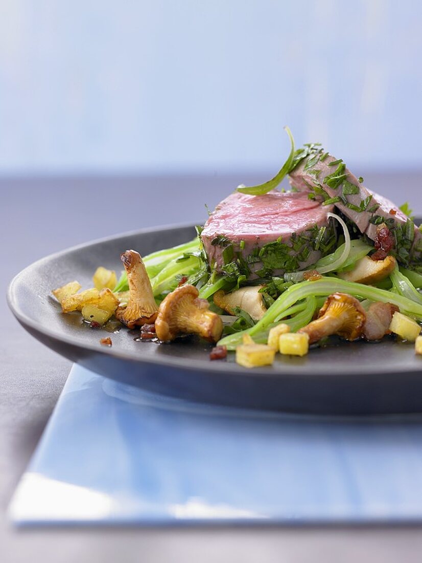 Veal fillet in herb stock on beans and chanterelles