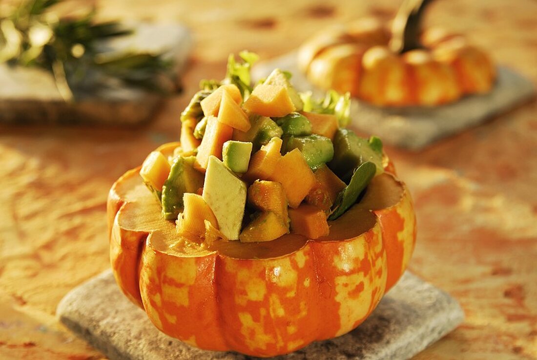 Avocado and pumpkin salad in hollowed-out pumpkin