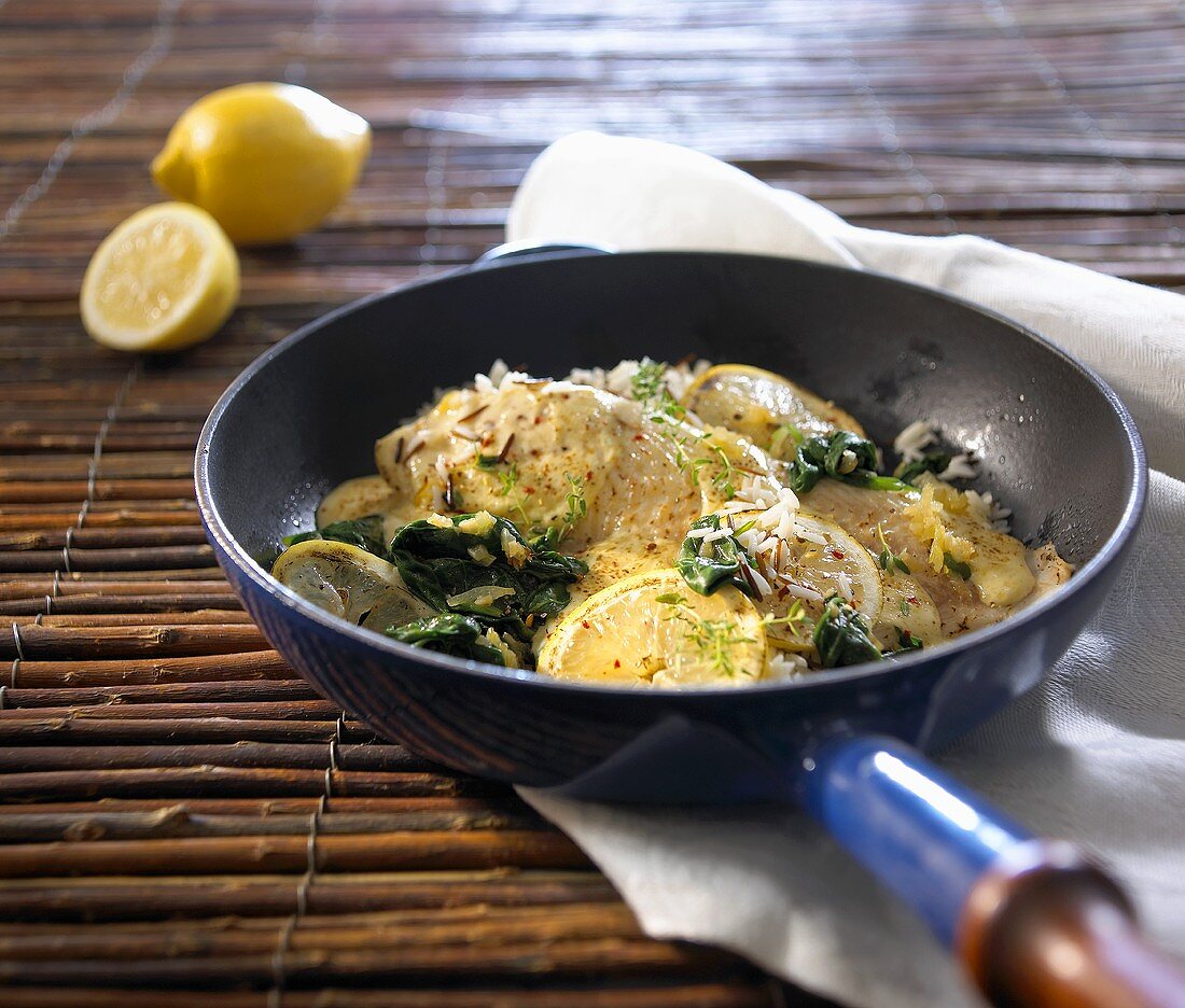 Plaice and spinach in a frying pan