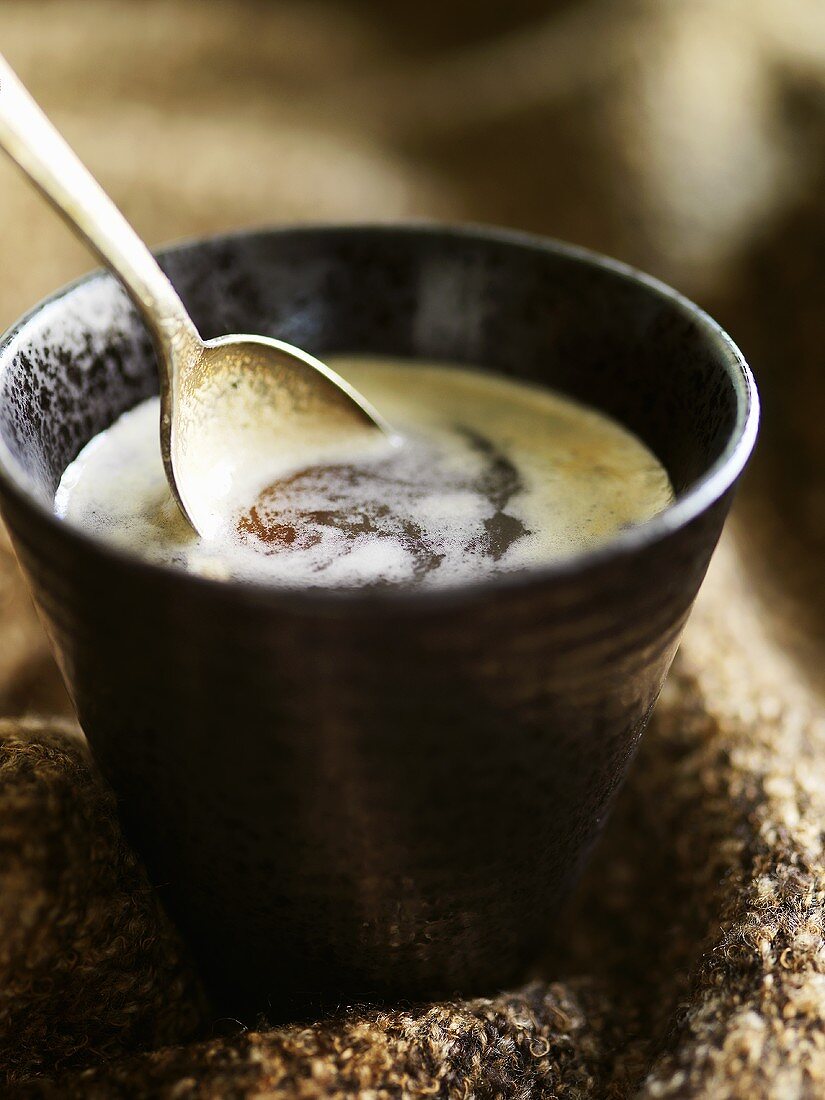 Coffee with spoon in a small bowl