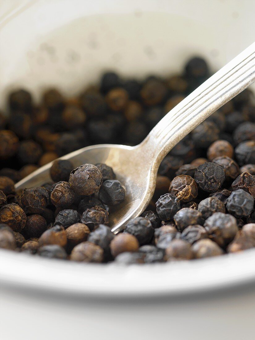 Black peppercorns with spoon