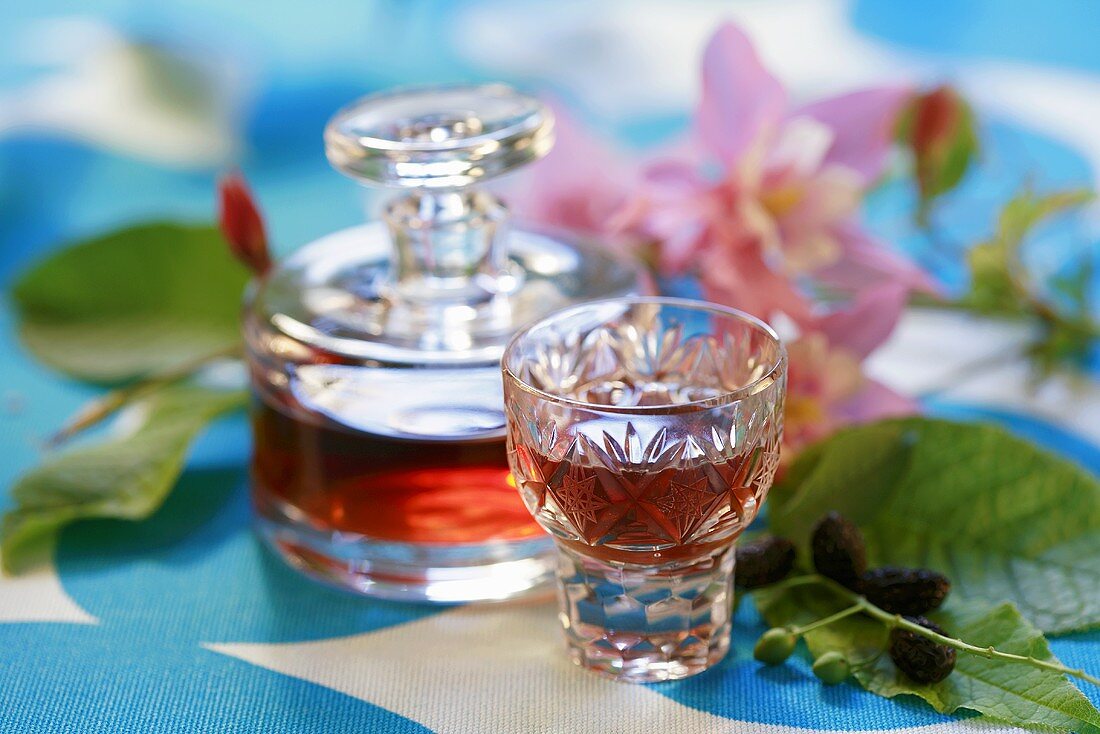 Cornel cherry liqueur in decanter and glass