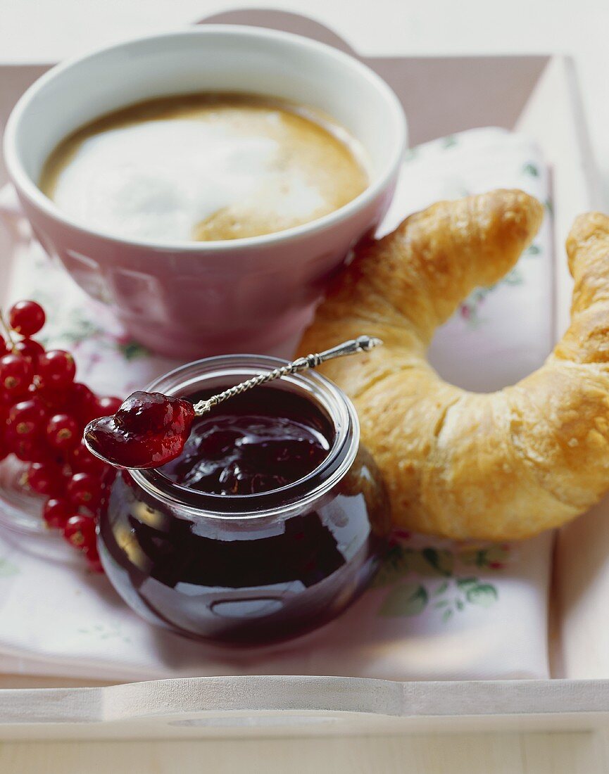 Redcurrant jelly, croissant and milky coffee