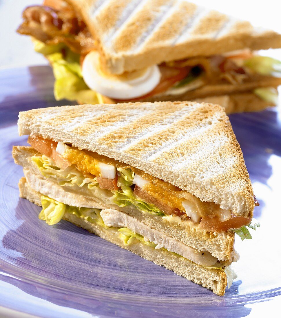 Club sandwich with chicken breast, bacon and egg