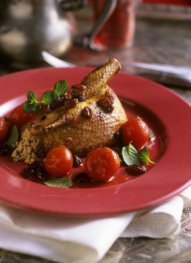 Honey-glazed pigeon with cherry tomatoes and sultanas