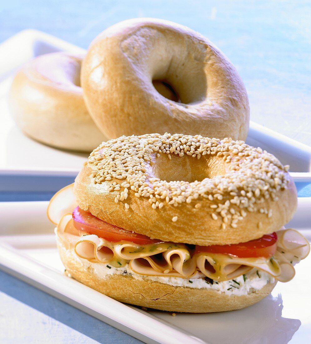Bagel filled with herb soft cheese and turkey breast