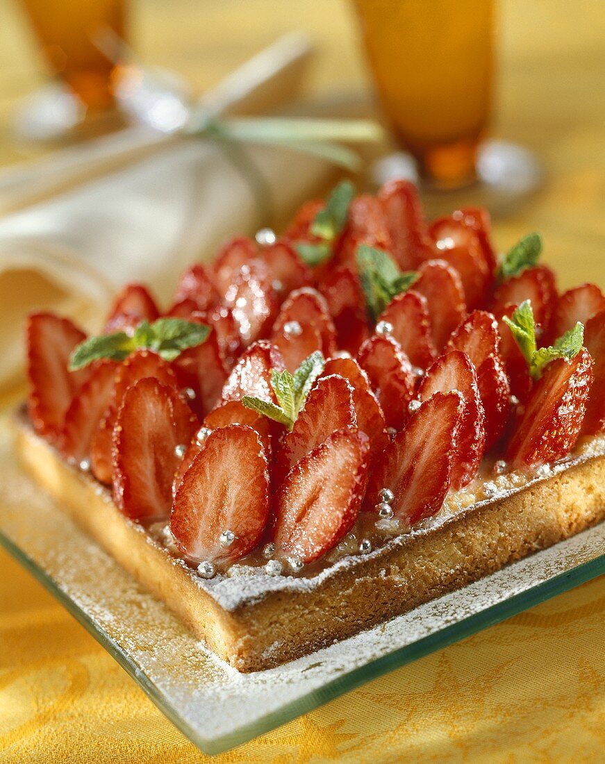 Strawberry cake with mint leaves and dragées