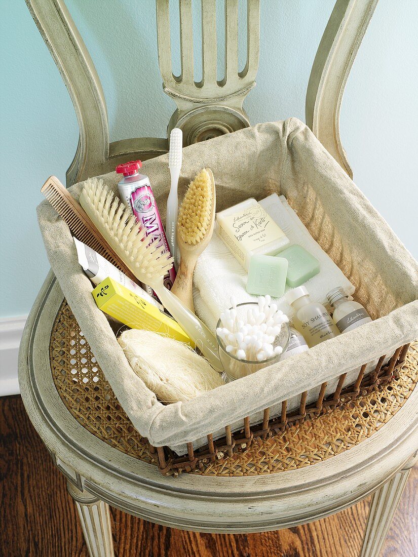 Basket of bathing accessories (hairbrush, toothbrush, soap etc.)