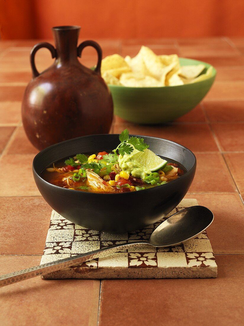Mexican soup with turkey, sweetcorn and guacamole