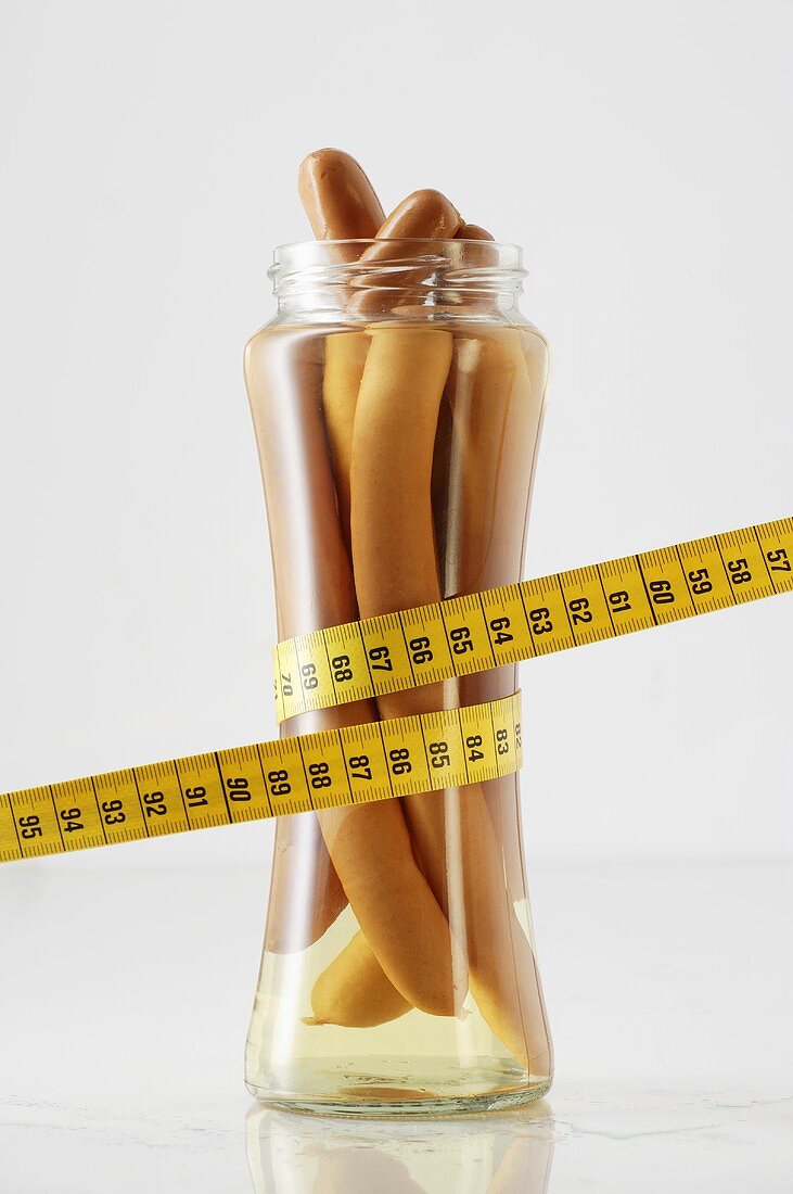 Sausages in a jar with tape measure