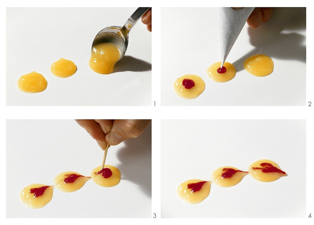 Making hearts with kiwi fruit puree and raspberry sauce