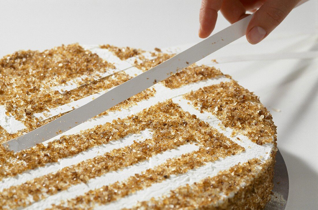 Removing strips of paper from a tea punch cake