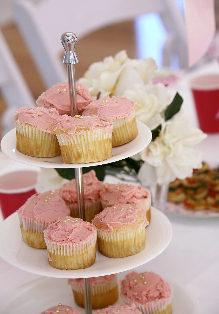 Cupcakes with pink icing on tiered stand