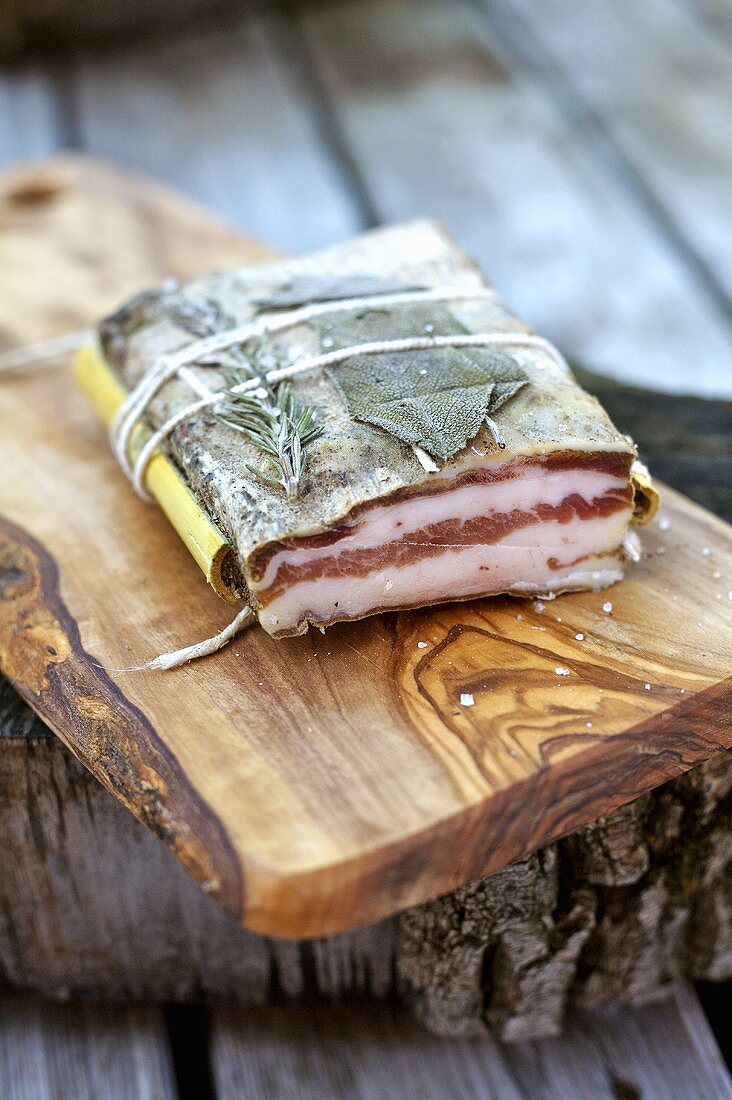 Herb-cured bacon, showing a cut edge