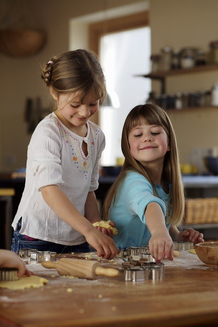 Two girls baking biscuits