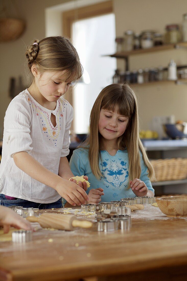 Two girls baking biscuits