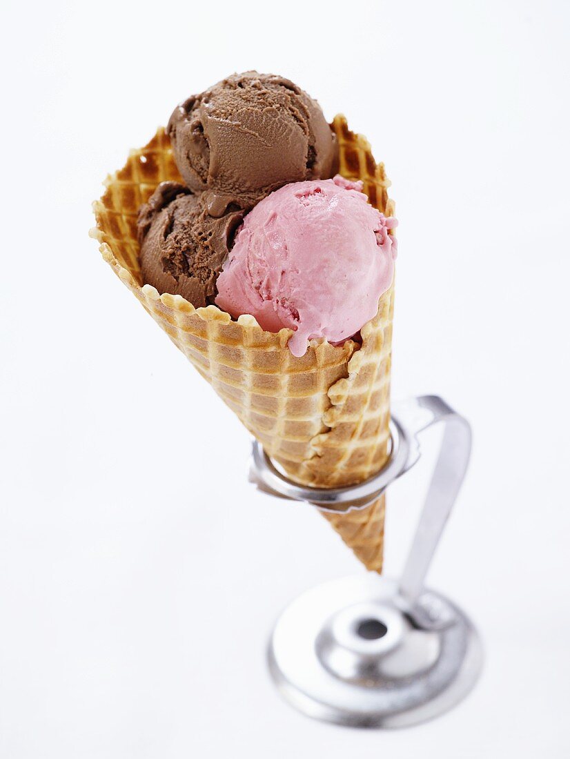 Strawberry and chocolate ice cream in a cone