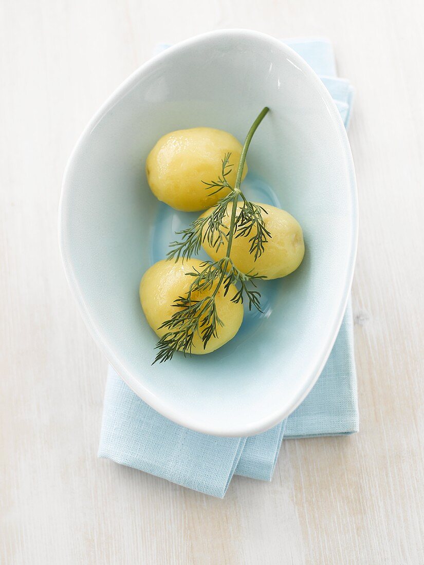 Three boiled potatoes with dill