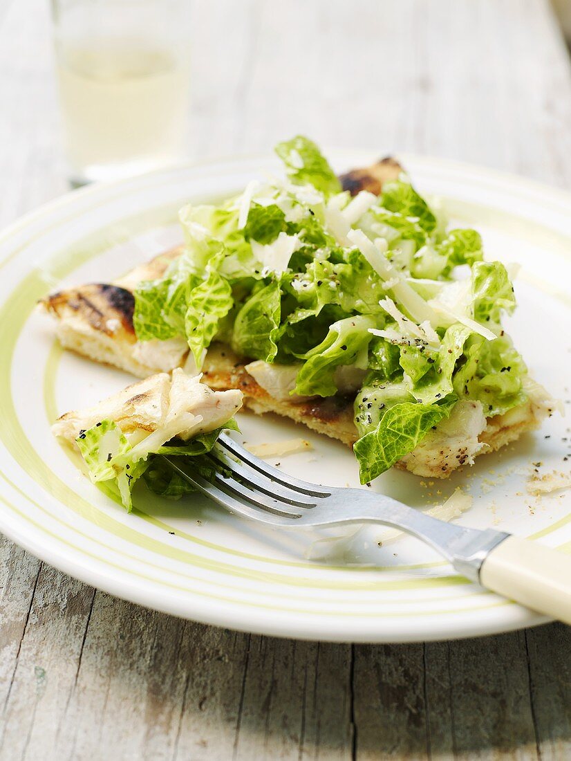 Caesar salad with chicken breast on pizza
