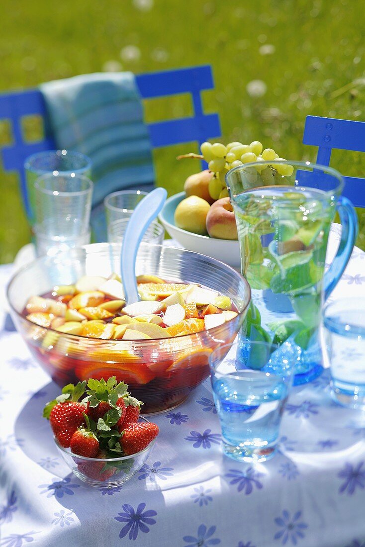 Sangria and water on summery table out of doors