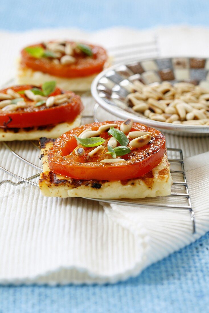 Grilled halloumi cheese with tomato and pine nuts