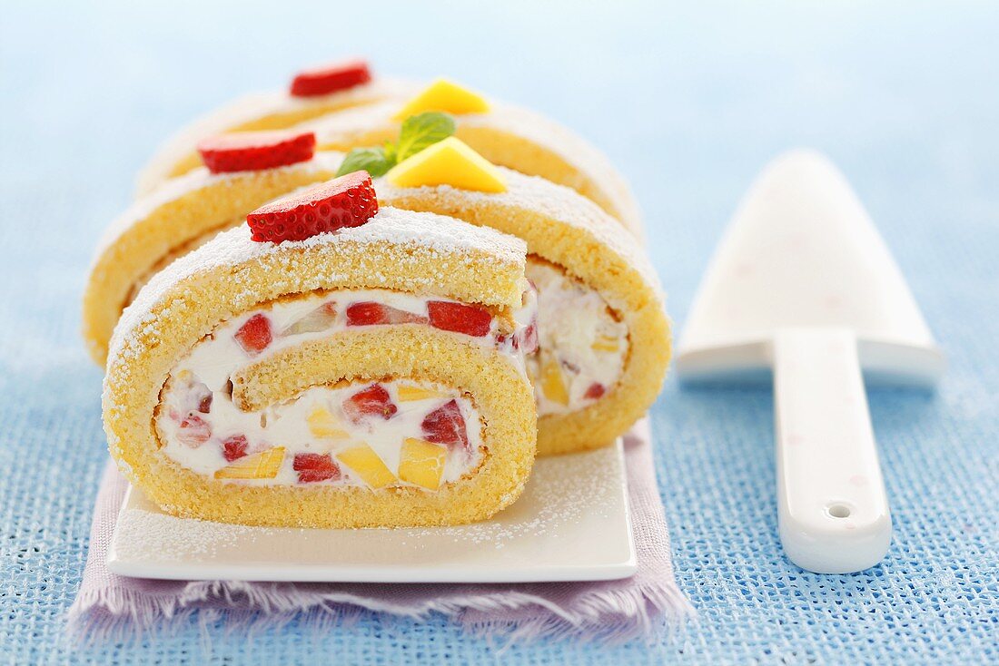 Sponge roll filled with mascarpone cream, mango & strawberries