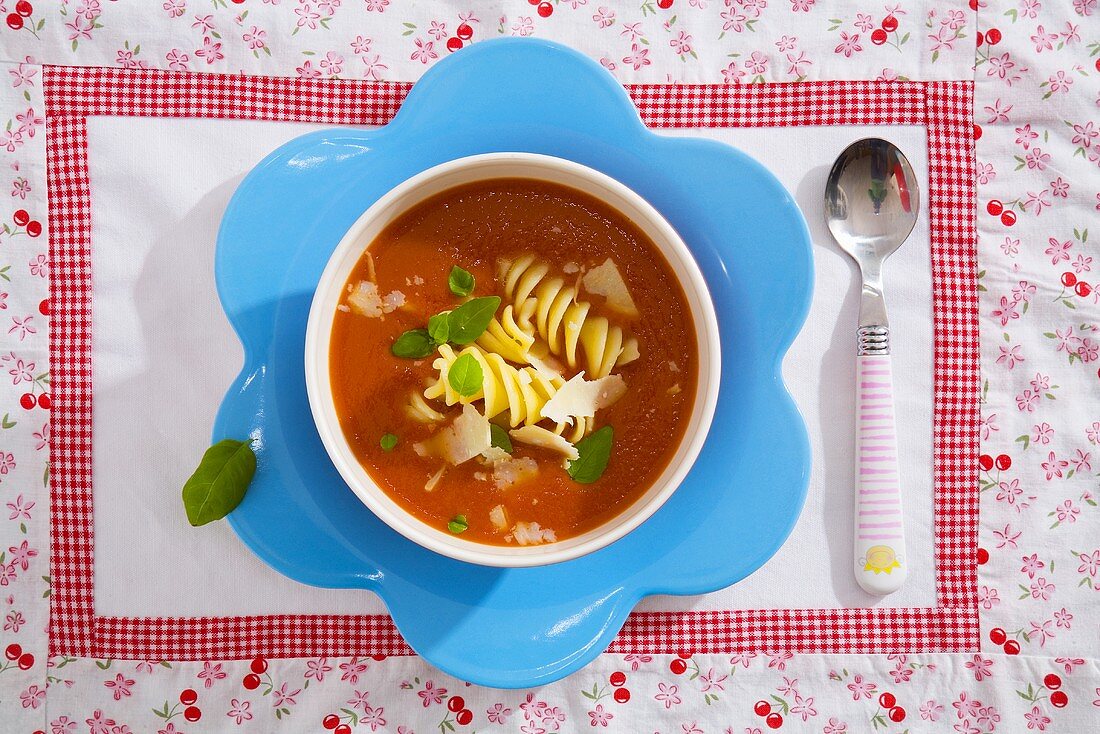 Tomato soup with pasta spirals, Parmesan and basil