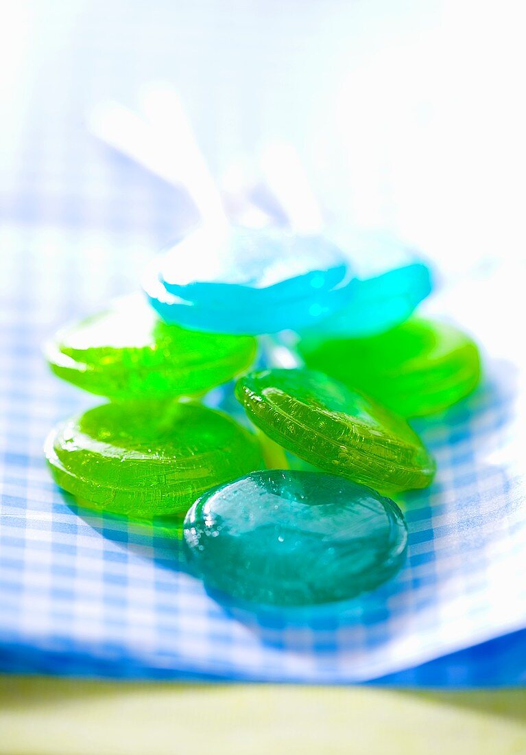 Blue and green lollipops on checked cloth