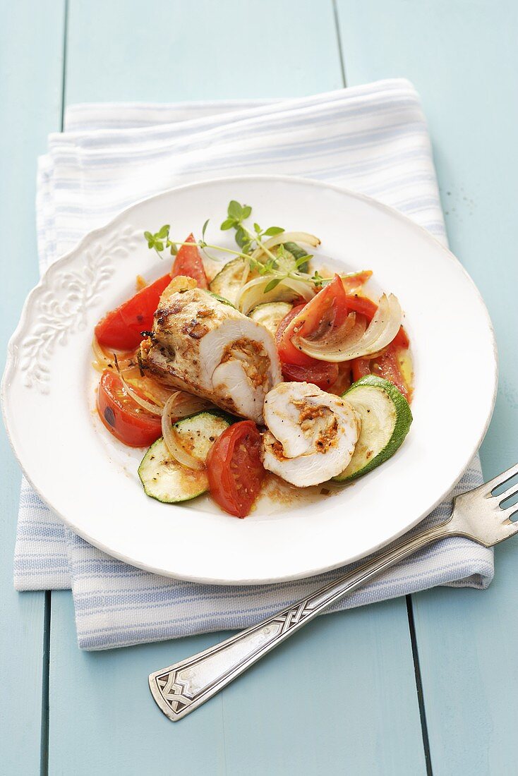 Chicken roulade on tomatoes and courgettes