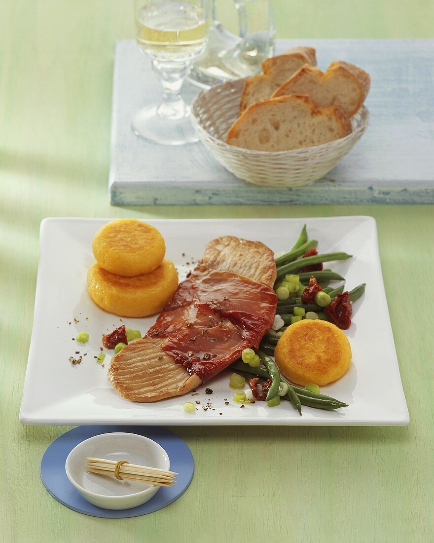 Pork escalope with ham, vegetables and potato cakes