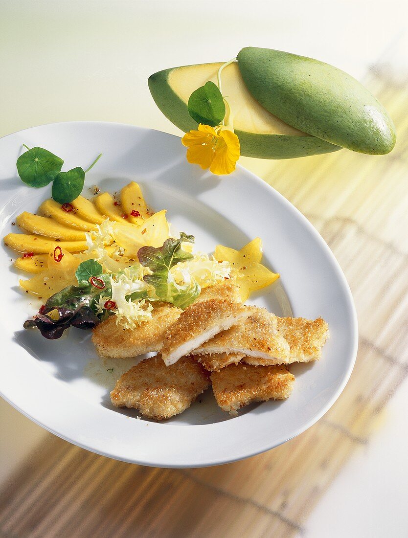 Coconut-coated chicken escalopes with mango salad